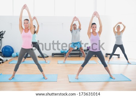 Full length of sporty class doing pilate exercises in the fitness studio