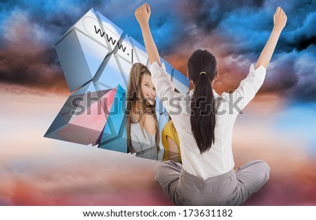 Businesswoman sitting cross legged cheering against blue orange cloudy sky background