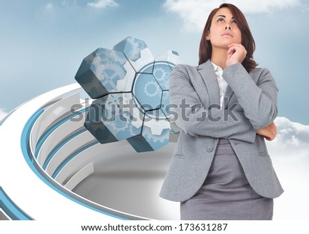 Focused businesswoman against blue and white structure in the sky