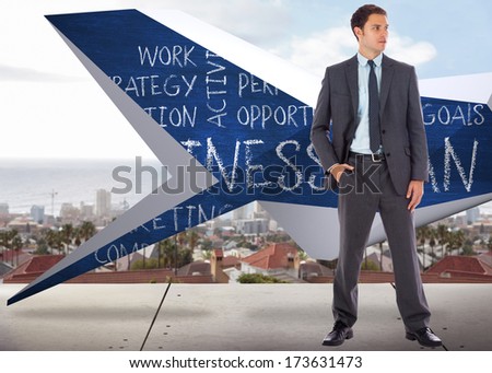 Serious businessman with hand in pocket against view from balcony over city