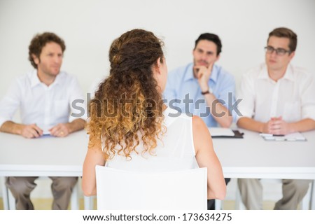 Panel of interviewers conducting job interview with female candidate