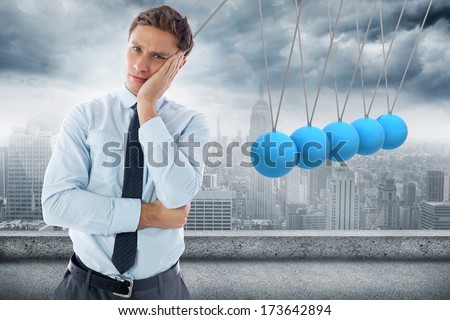 Upset thinking businessman against abstract yellow line design on blue sky