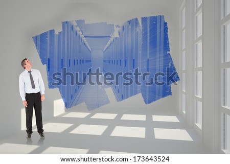 Businessman looking up against road turning into arrow