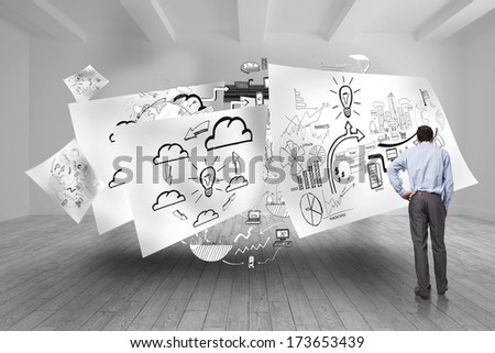 Businessman with hand on hip against balcony and stormy sky