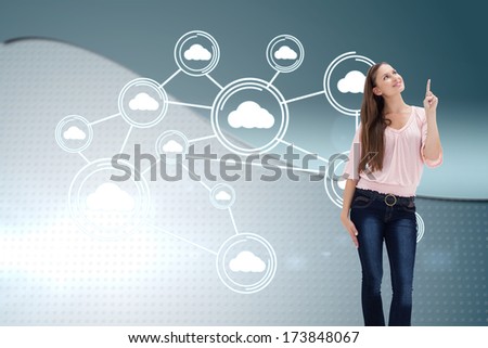 Young woman pointing upwards against wave on futuristic background