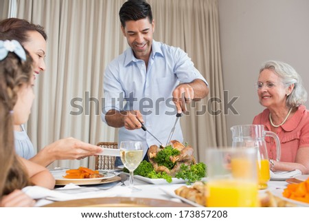 Extended family sitting at dining table in the house