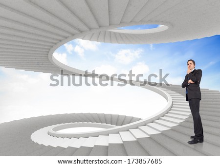 Thinking businessman touching chin against spiral staircase in the sky