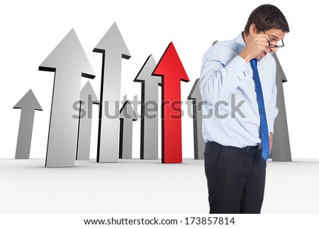 Thinking businessman tilting glasses against red arrow pointing down
