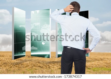 Thinking businessman scratching head against bright brown landscape