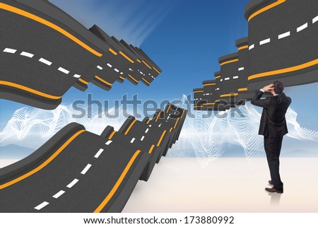 Stressed businessman with hands on head against city on the horizon