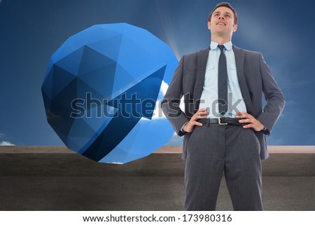 Happy businessman with hands on hips against balcony and sunny sky