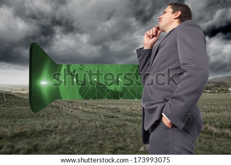 Thoughtful businessman with hand on chin against stormy countryside background