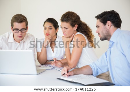 Senior business people using laptop in meeting room