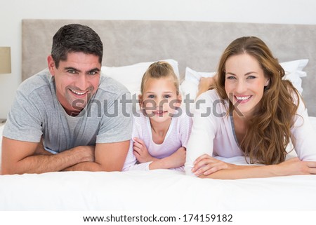 Portrait of happy family in bed