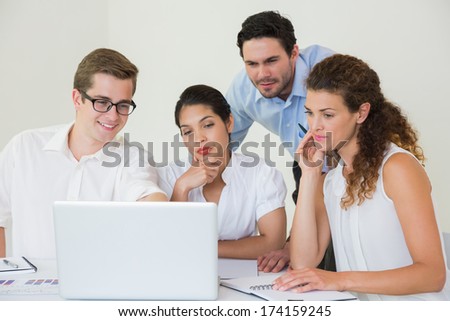 Business People Looking At Laptop In Office