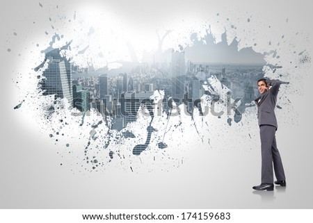 Thinking businessman scratching head against splash on wall revealing cityscape