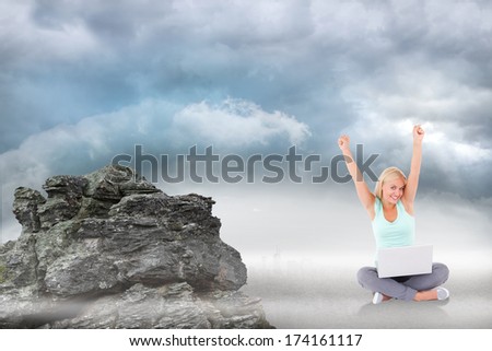 Joyful woman with a notebook against rocky landscape