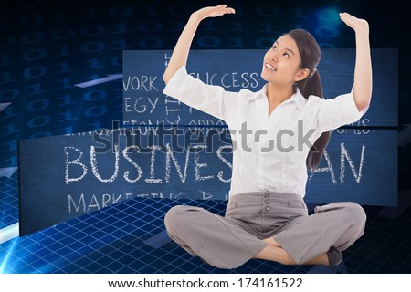 Businesswoman sitting cross legged pushing up against grid and arrows on black background