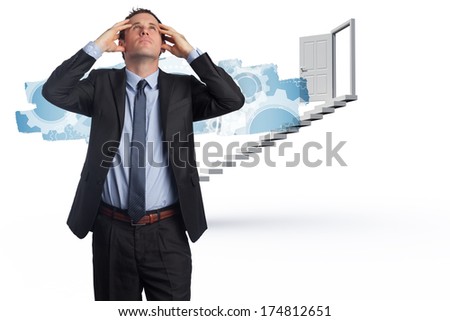 Stressed businessman with hands on head against abstract screen in room showing cogs and wheels