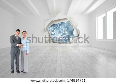 Business partners with clipboard against rip on wall showing technology interface