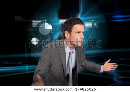 Businessman posing with hands out against doorway on technological black background