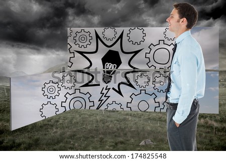Happy businessman standing with hand in pocket against stormy countryside background
