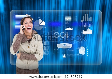 Laughing cute brunette in winter fashion phoning against futuristic blue black background