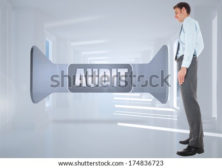 Happy businessman standing with hands in pockets against bright white hall with columns