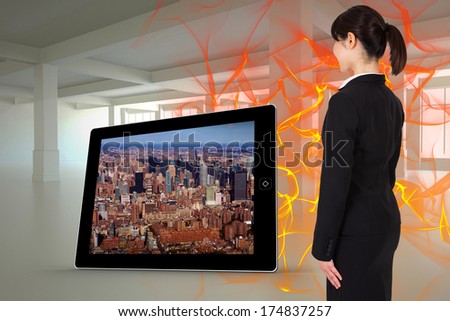 Businesswoman standing against abstract design in orange