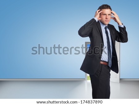 Stressed businessman with hands on head against door opening showing blue sky