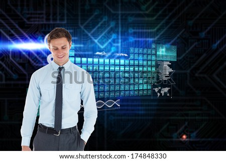 Smiling businessman standing with hand in pocket against futuristic black and blue background