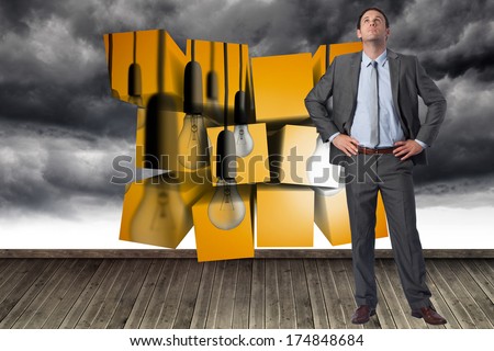 Serious businessman with hands on hips against cloudy sky painted on wall