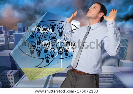 Businessman standing with arms pushing up against digitally generated cityscape