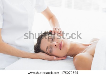 Beautiful woman receiving head massage in health spa