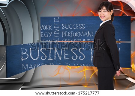 Smiling businesswoman against orange energy design on a futuristic structure
