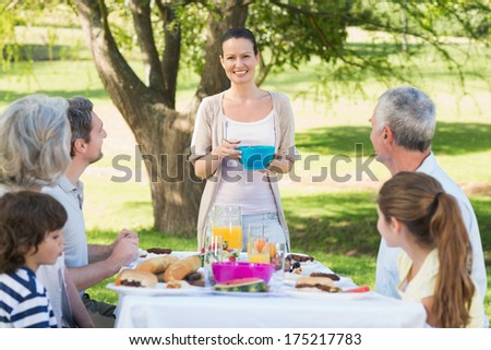 Side view of an extended family having lunch in the lawn