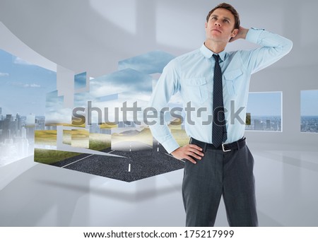 Thoughtful businessman with hand on head against bright white room with windows
