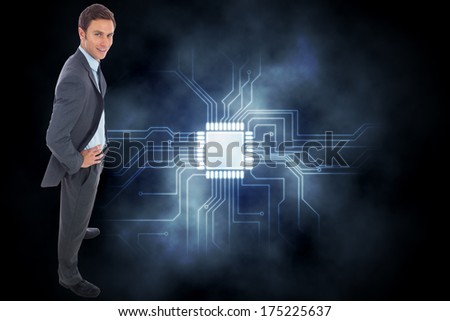 Cheerful businessman standing with hands on hips against circuit board graphic