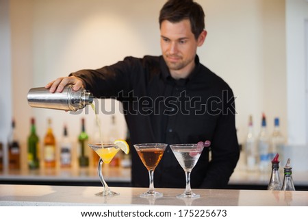 Bartender pouring cocktails at the bar