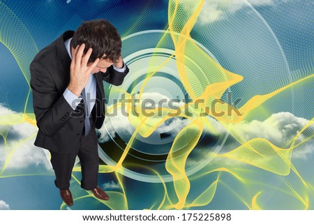 Stressed businessman with hands on head against yellow lines with cloud design on a futuristic structure