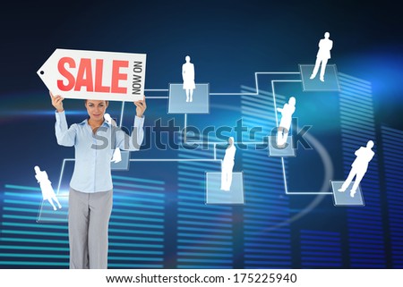 Businesswoman holding sign above her head against glowing blue bar chart on black background