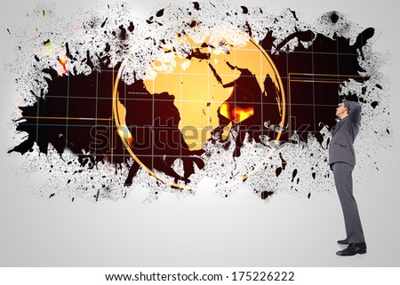 Thinking businessman scratching head against splash on wall revealing earth graphic