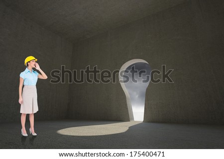 Attractive architect yelling against keyhole door in dark room