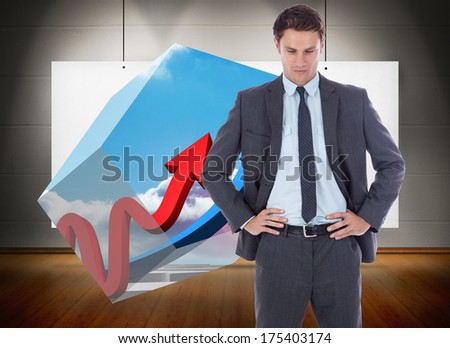 Serious businessman with hands on hips against poster hung and exhibited like art