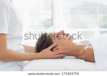 Side view of woman receiving body massage in health spa