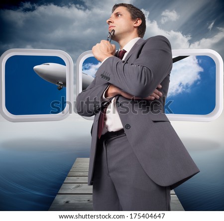Thinking businessman holding his glasses against cloudy sky over ocean