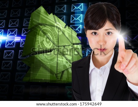 Focused businesswoman pointing against glowing envelopes on black background