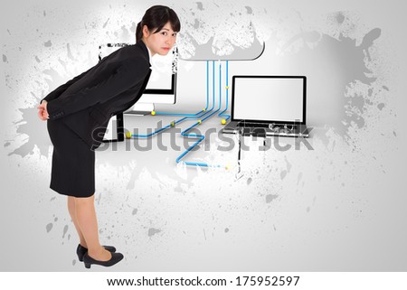 Serious businesswoman bending against splash on wall revealing file transfer graphic