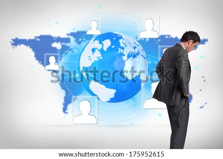 Businessman with hands on hips against blue world map on white background