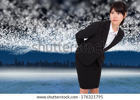 Serious businesswoman bending against bright stars of energy over landscape